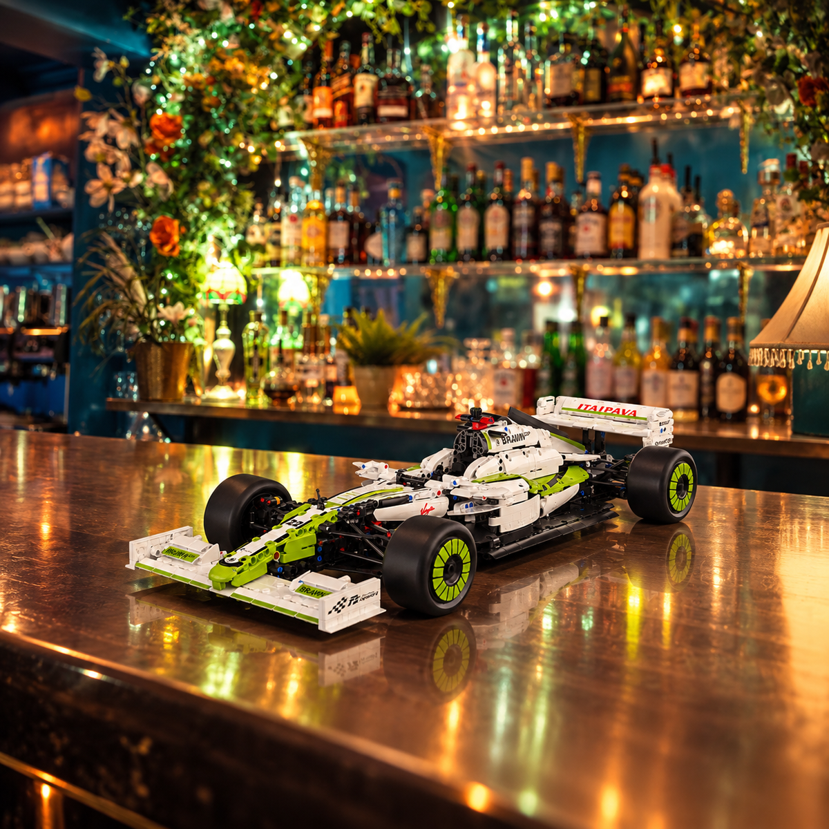 Green and white brick-built racing car displayed on a bar counter under amber lighting