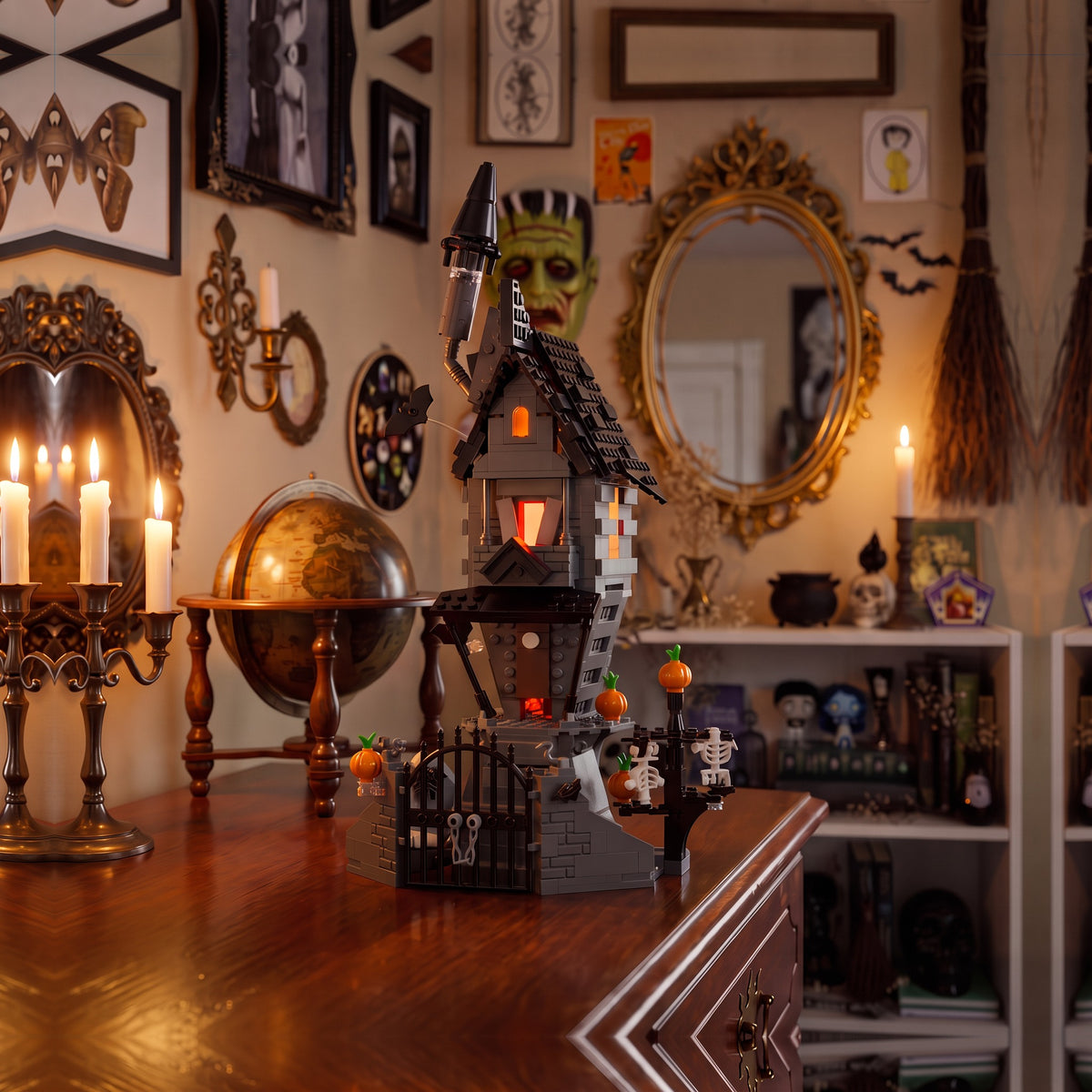 Brick-built Jack's House from The Nightmare Before Christmas on a wooden dresser in front of a gallery wall with a gold mirror and candelabra