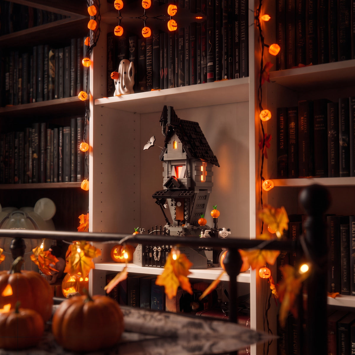 Brick-built Jack's House from The Nightmare Before Christmas on a white bookshelf with pumpkin string lights and Halloween decor