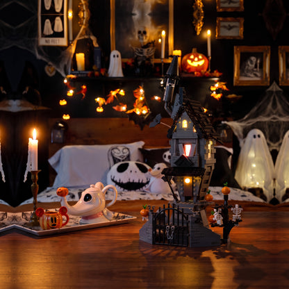 Brick-built Jack's House from The Nightmare Before Christmas on a wooden table in a candlelit gothic bedroom with a glowing ghost